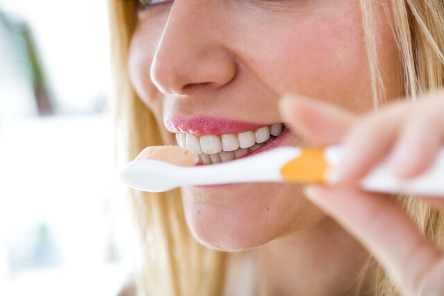 pretty-young-blonde-woman-cleaning-her-teeth.jpg