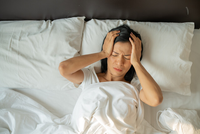 unhappy-exhausted-mature-woman-with-closed-eyes-lying-bed-touching-temples-close-up-tired-female-suffering-from-headache-migrain