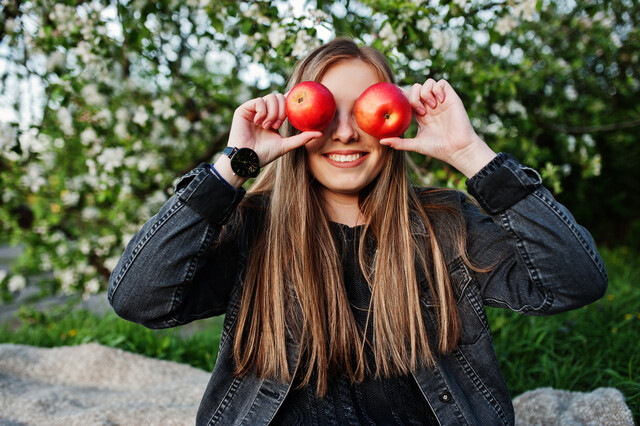 young-brunette-girl-jeans-sitting-plaid-against-spring-blossom-tree-show-apple-eyes.jpg