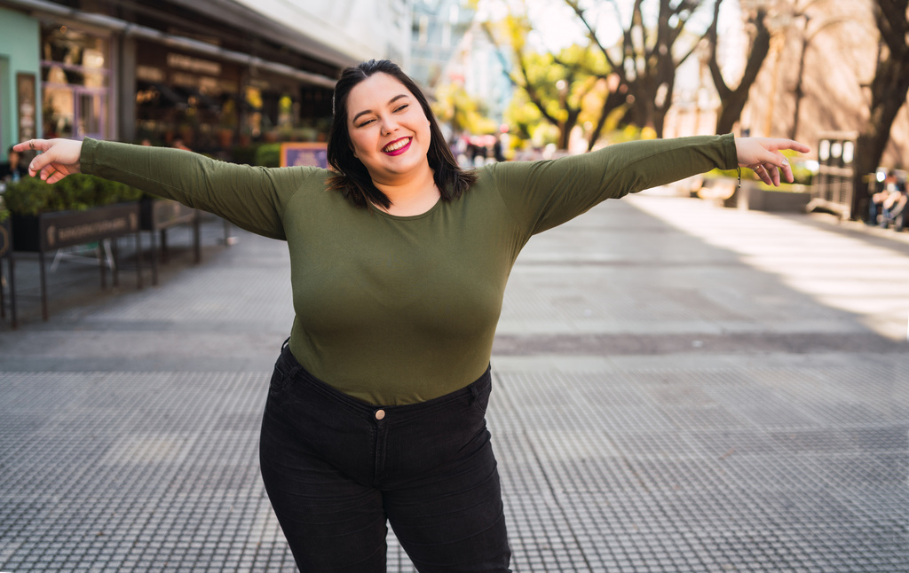 portrait-young-plus-size-woman-smiling-while-standing-outdoors-street-urban-concept.jpg