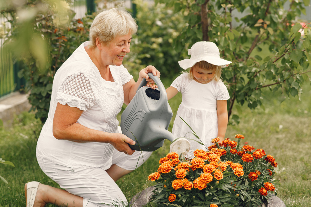 small-girl-with-senior-grandmother-gardening-backyard-garden-child-white-hat.jpg