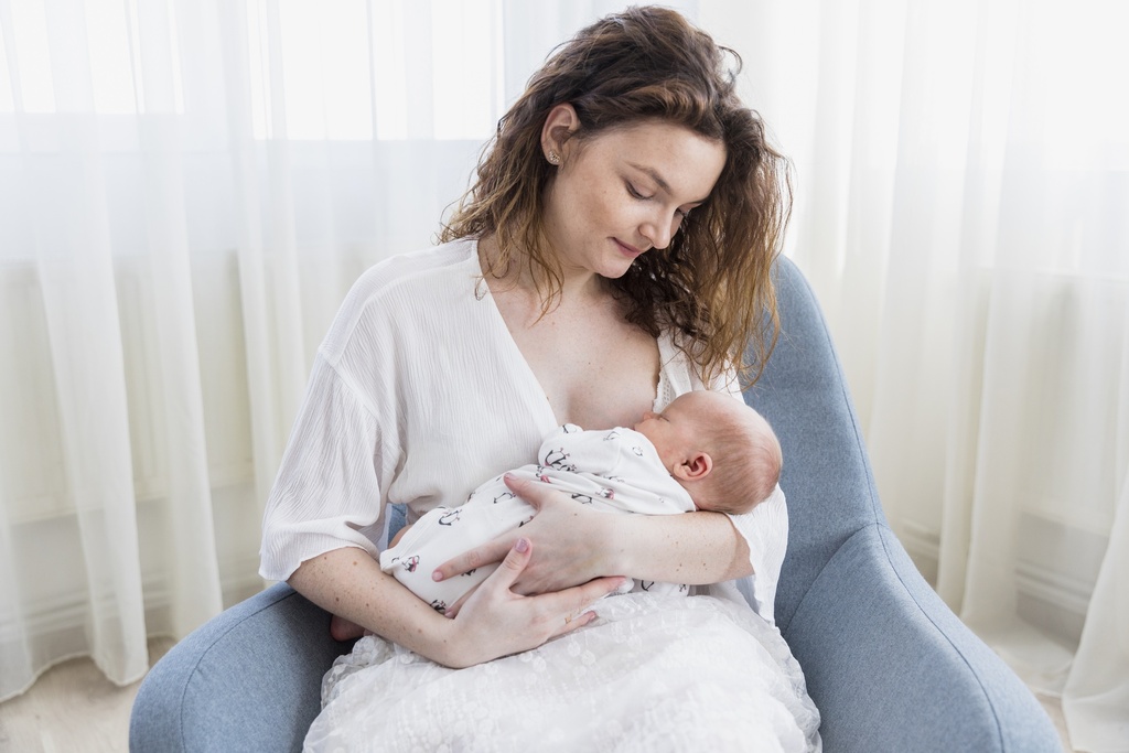 smiling-mother-with-her-baby-sitting-arm-chair.jpg